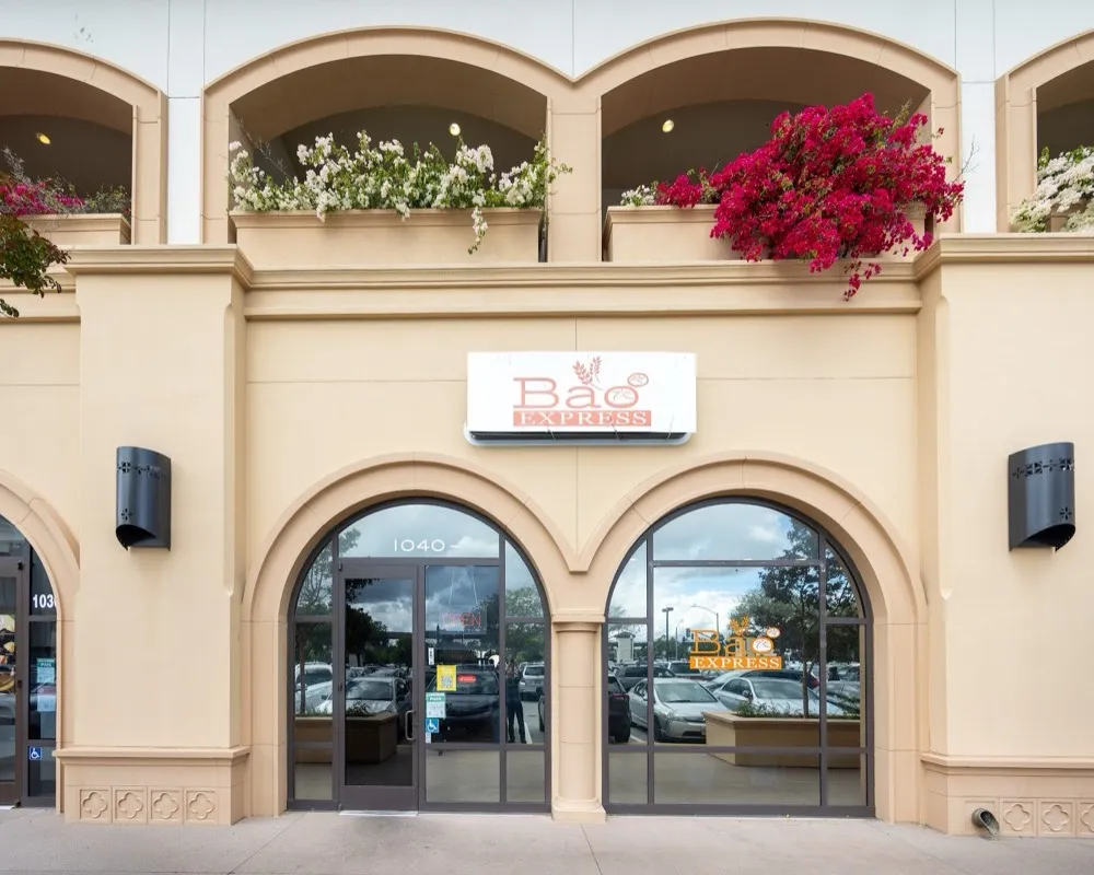 The Bao Express storefront at 1040 Park Place in San Mateo with arched windows and bougainvillea