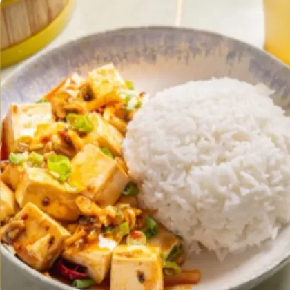 Mapo tofu with soft tofu cubes, chili sauce and spring onion served beside steamed white rice at Bao Express