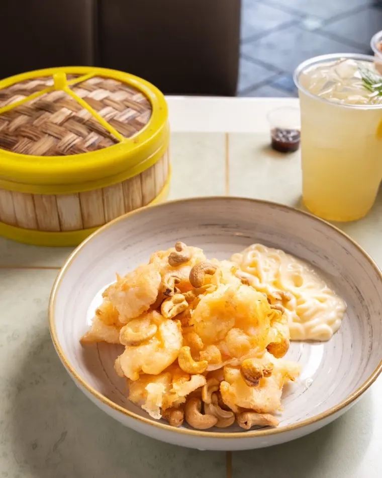 Honey walnut shrimp in a creamy glaze with candied walnuts served in a bowl