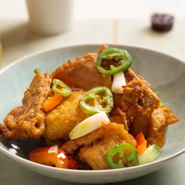 Salt and pepper fried chicken tossed with sliced jalapeno and sweet pepper