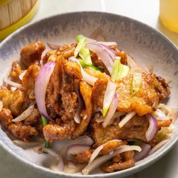 Crispy salt and pepper pork tossed with shredded onion and spring onion