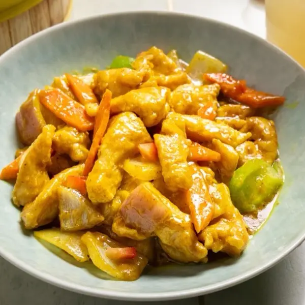 Curry chicken with celery, carrot and onion in a golden sauce