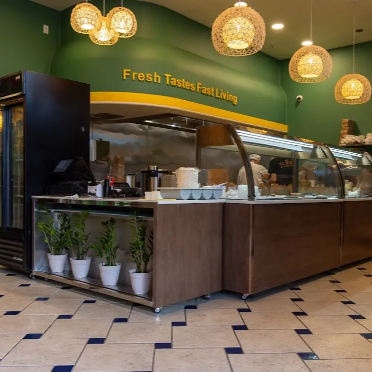 The Bao Express service counter with warm pendant lighting and a green tiled front